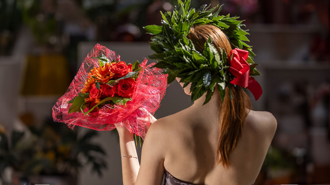 Una modella indossa una corona di laurea e un bouquet realizzati per festeggiare un grande traguardo